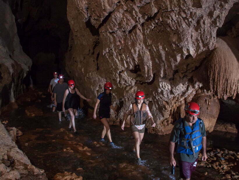 group walking in atm cave