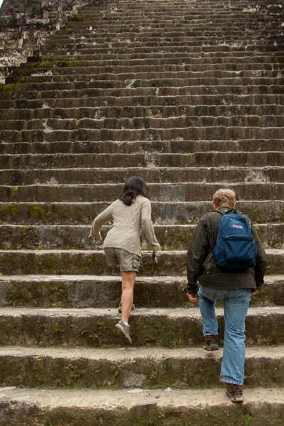 couple walk the mayan ruins steps