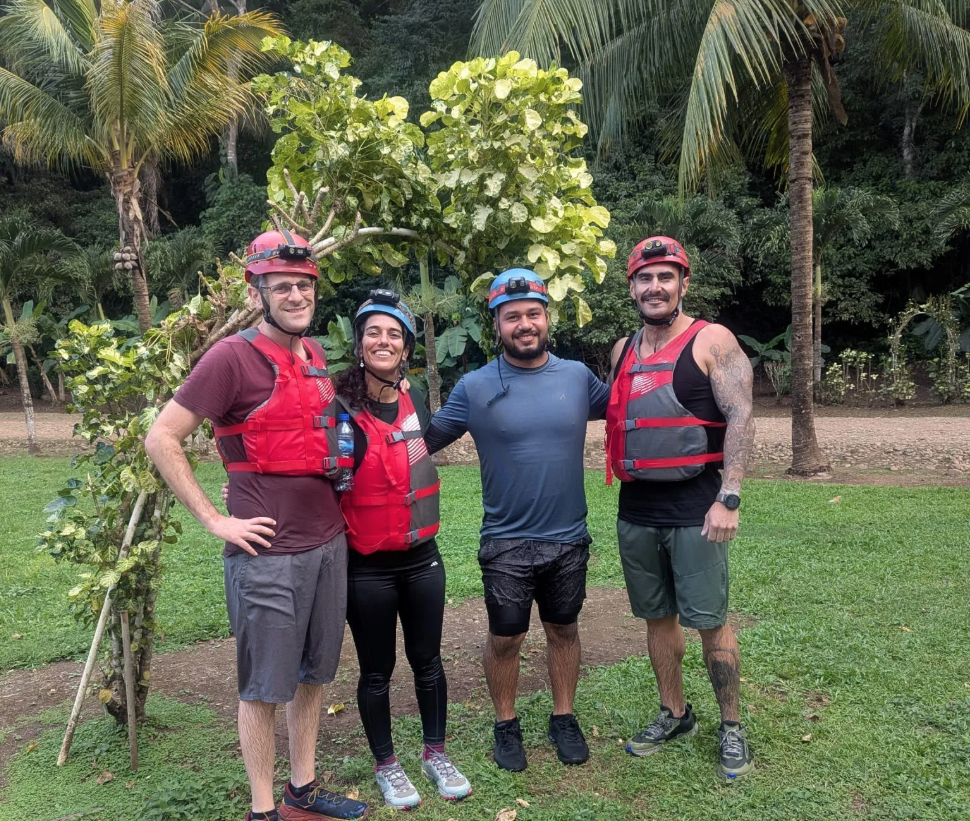 Pacz Tours guide Jahir with three travelers in caving gear after completing the ATM Cave tour in Belize on December 6, 2024