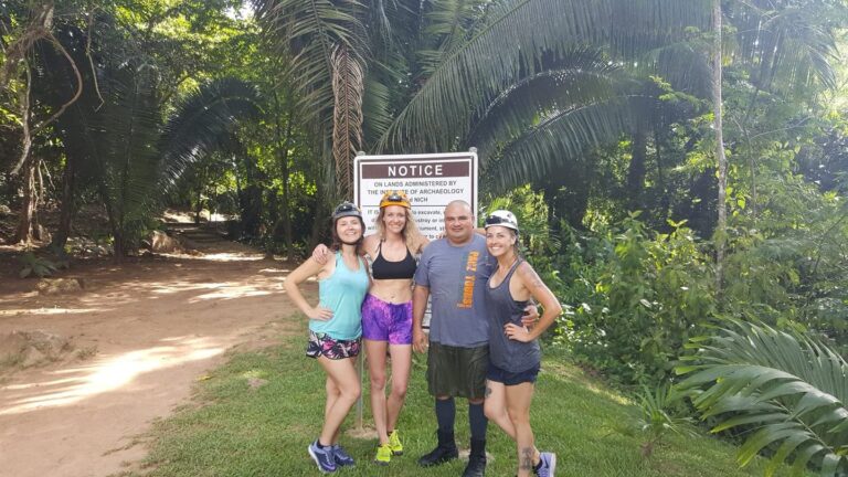Pacz Tours guide Emilio with a group of ladies posing near the trail to the ATM Cave in Belize, jungle background, September 25, 2018