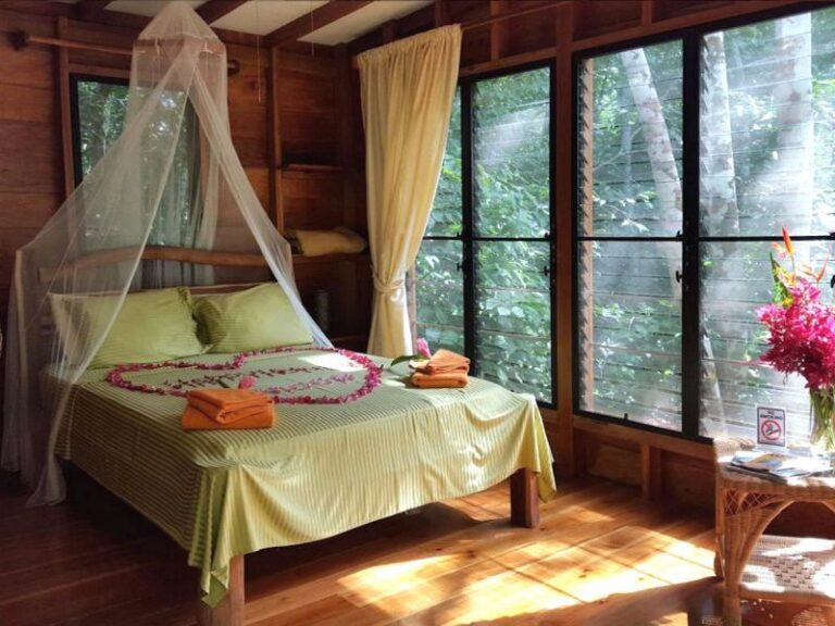 Bedroom at Vanilla Hills Lodge in San Ignacio, Belize with rustic wooden design and cozy atmosphere